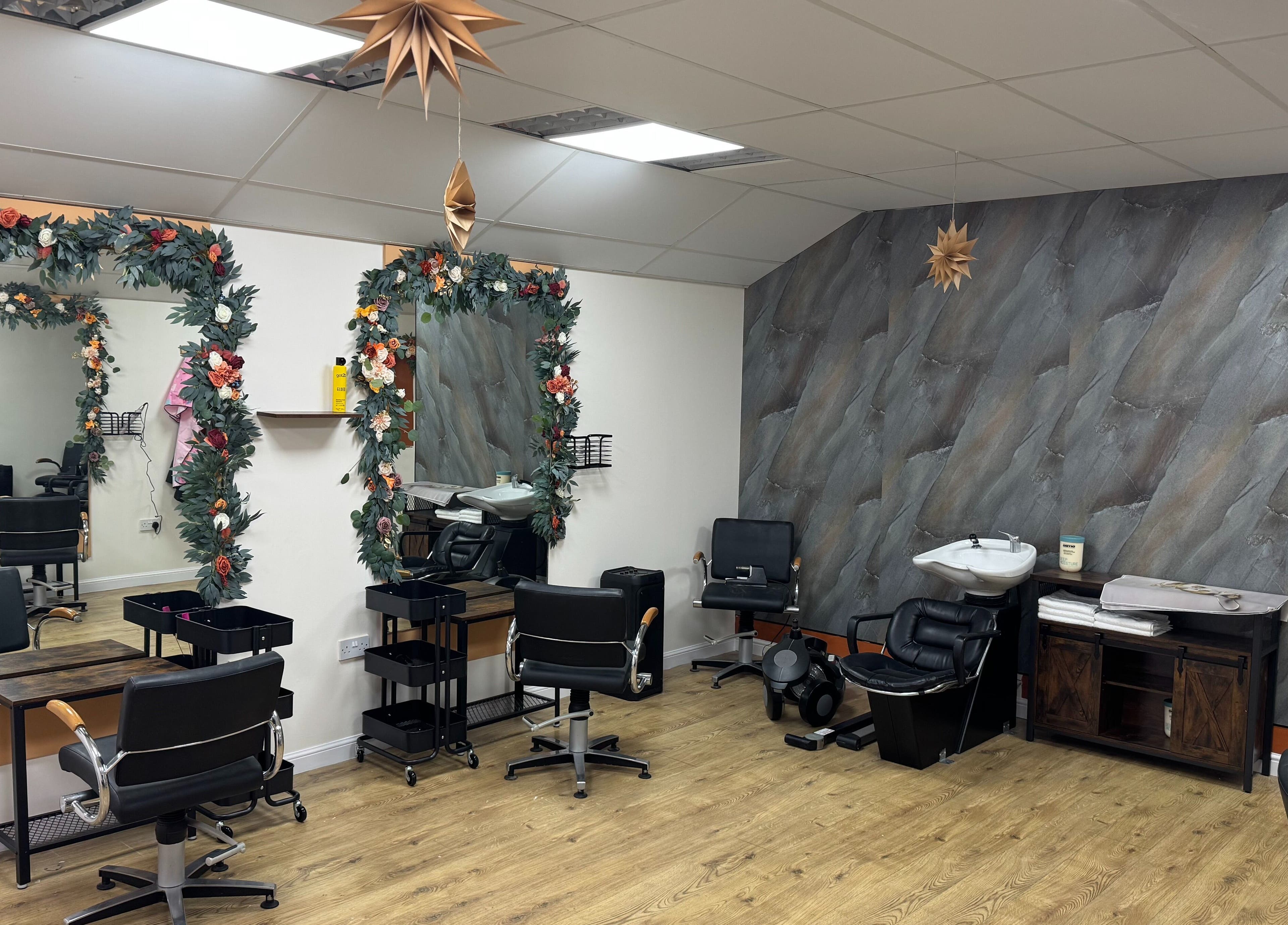Stylish interior of Murphys Hair & Beauty Salon Limited in East Calder, Scotland, GB, featuring decorated mirrors.