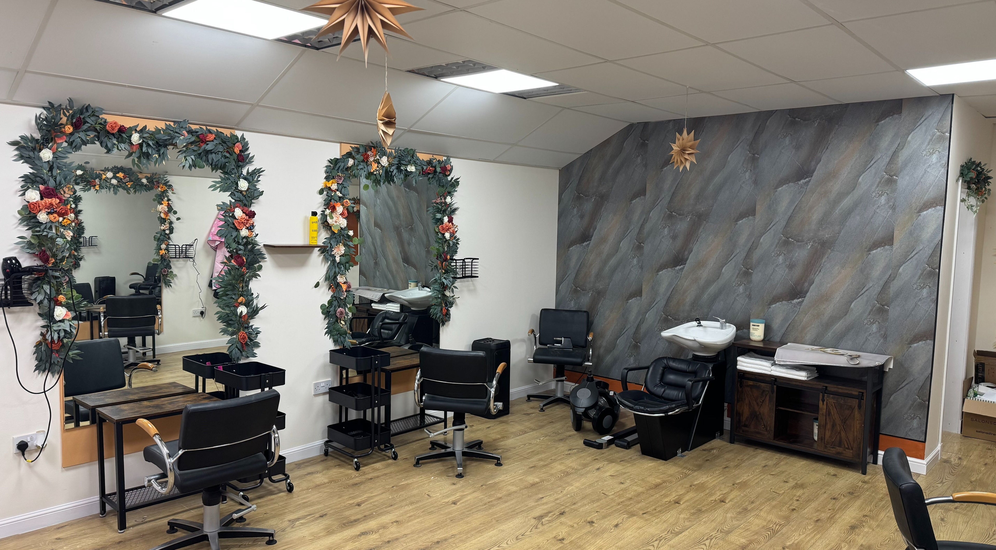 Stylish interior of Murphys Hair & Beauty Salon Limited in East Calder, Scotland, GB, featuring decorated mirrors.