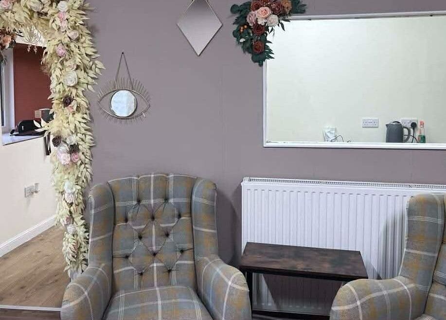 Elegant seating area with floral accents at Murphys Hair & Beauty Salon Limited, East Calder, Scotland, GB.