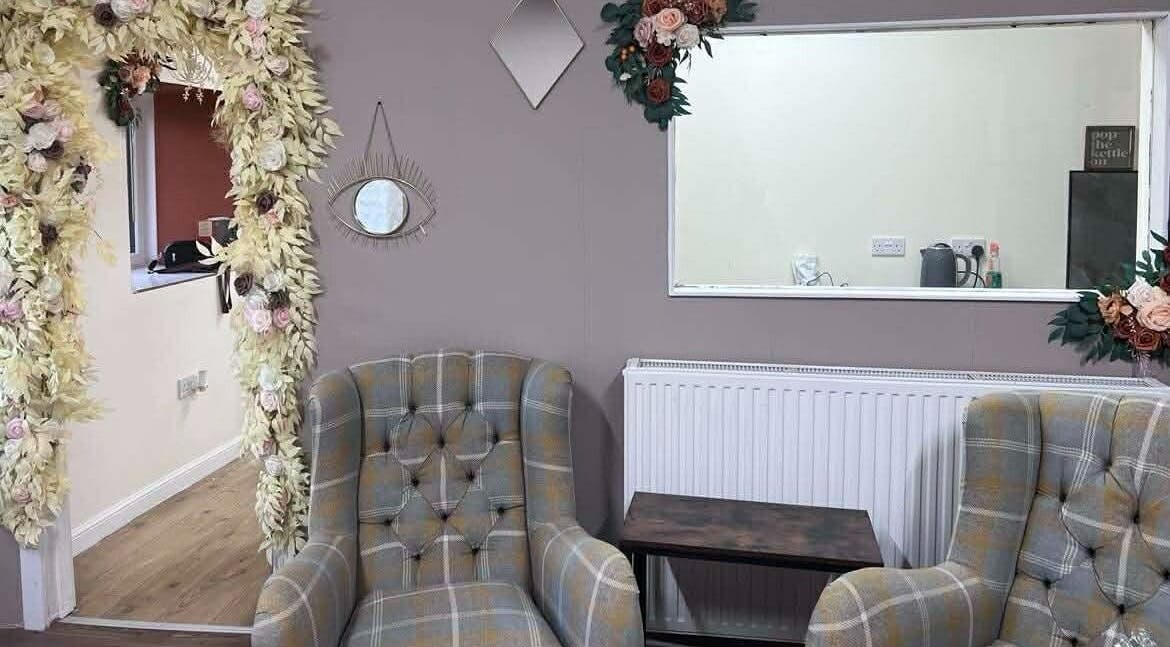 Elegant seating area with floral accents at Murphys Hair & Beauty Salon Limited, East Calder, Scotland, GB.