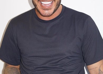 Man with tattoos on arm smiles at Dean Aesthetics, Little Lever, England, GB.