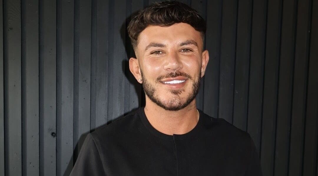 Friendly staff member at Dean Aesthetics, Prestwich, England, GB, showcasing a warm smile against a stylish backdrop.