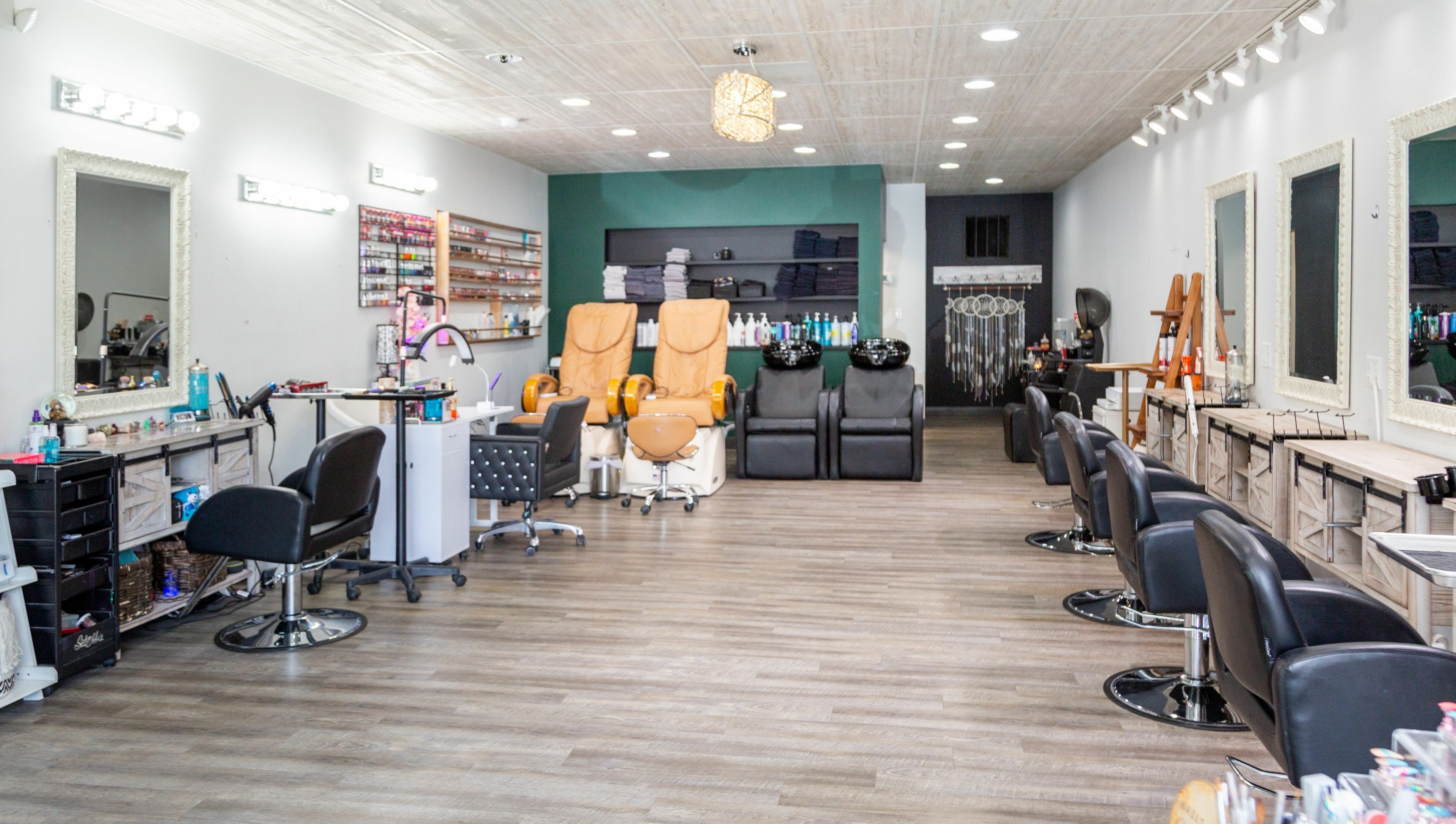 Interior of Artistic Mindz salon in Highland, Indiana, US featuring styling stations and pedicure chairs.