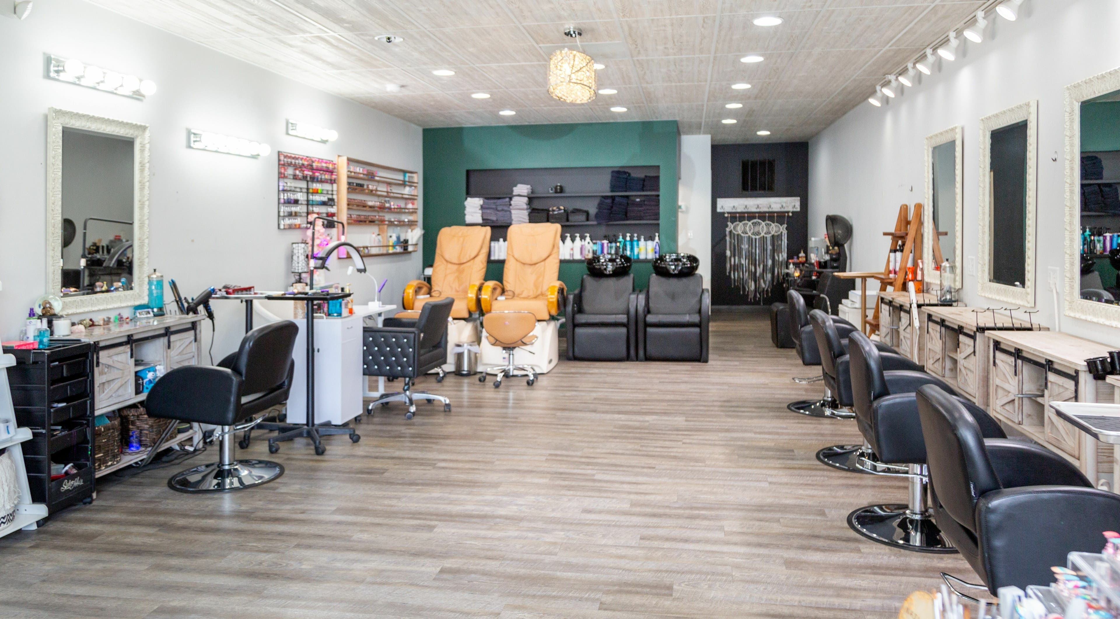 Interior of Artistic Mindz salon in Highland, Indiana, US featuring styling stations and pedicure chairs.