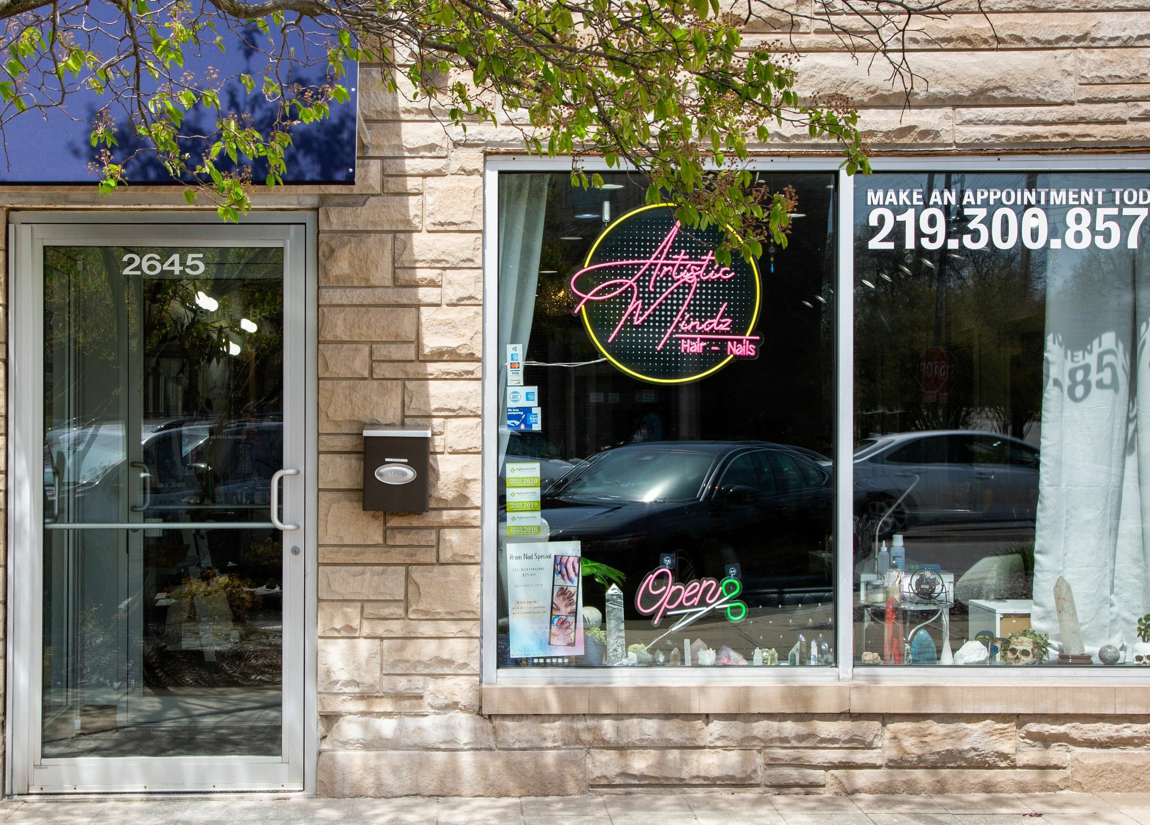Front view of Artistic Mindz salon in Highland, Indiana, showing modern signage and entrance.