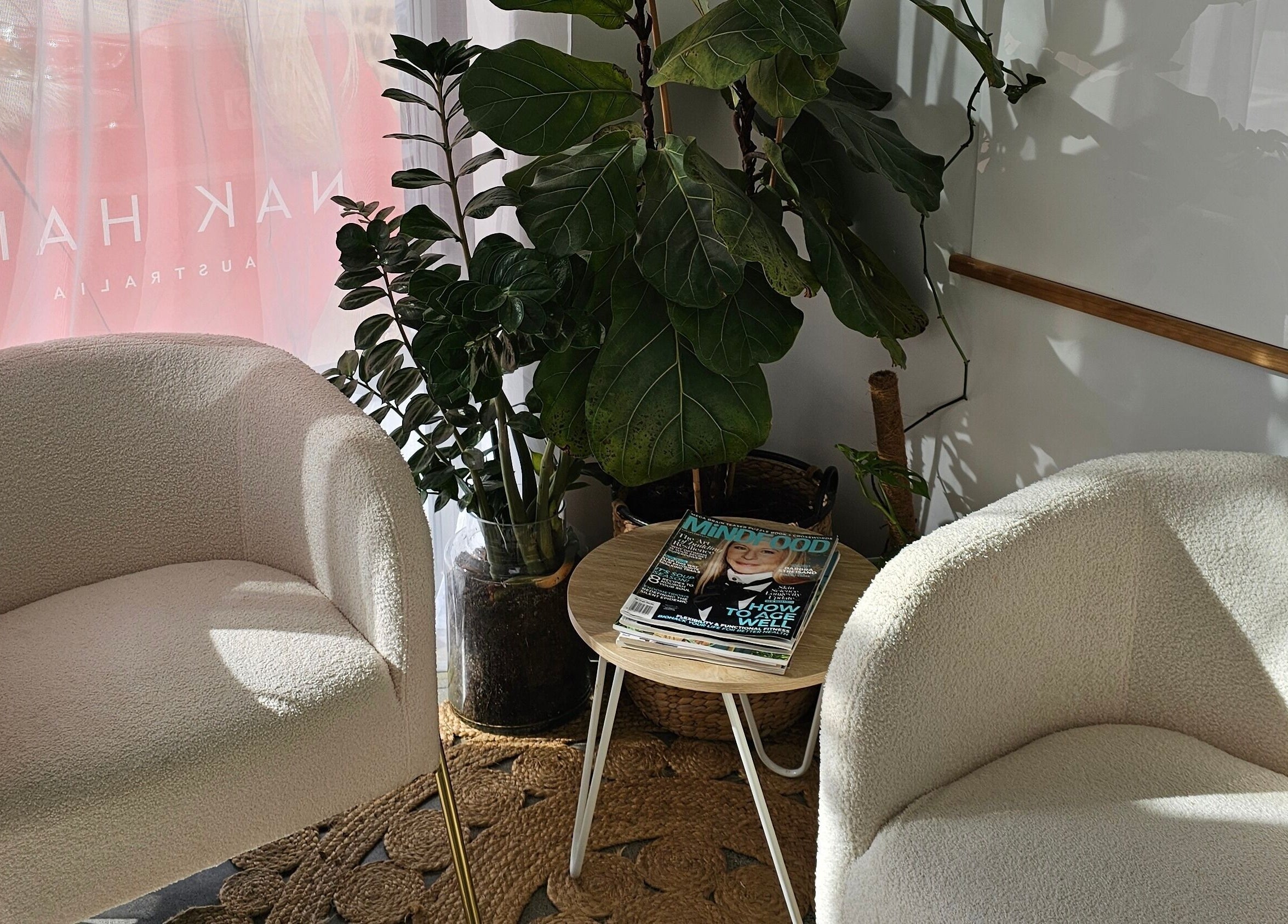 Cozy waiting area at Loretta's Hair Spa, Papamoa, Bay Of Plenty, NZ with plush chairs and plants.
