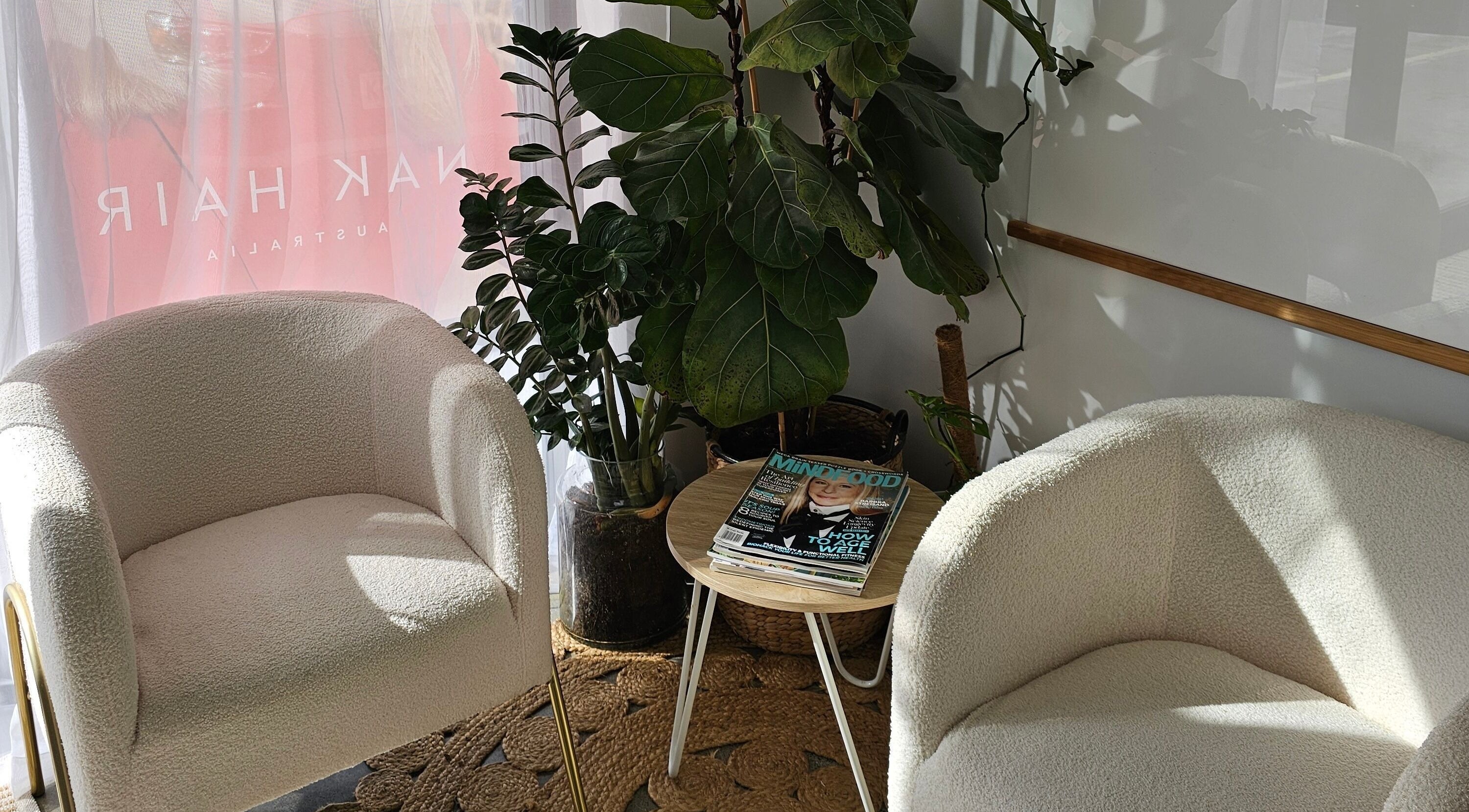 Cozy waiting area at Loretta's Hair Spa, Papamoa, Bay Of Plenty, NZ with plush chairs and plants.