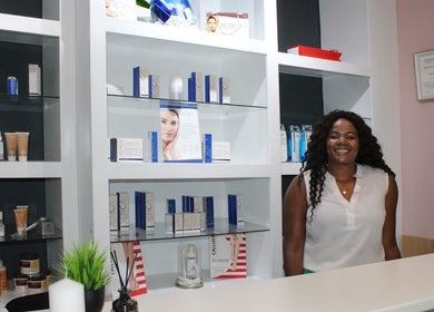 Reception area at Laser Hair Removal Lansdowne, Rosa beauty spa in Cape Town, Western Cape, ZA, with skincare products displayed.