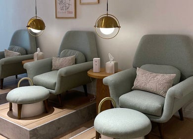 Cozy pedicure chairs at The Glam Studio | ذا جلام ستوديو in Riyadh, Riyadh Province, SA under soft lighting.