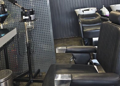 Interior of Double Cut Barbershop | صالون دبل كت in Riyadh, featuring modern barber chairs.