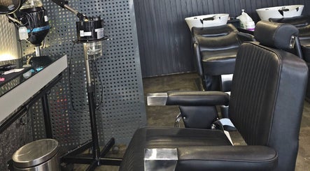 Interior of Double Cut Barbershop | صالون دبل كت in Riyadh, featuring modern barber chairs.