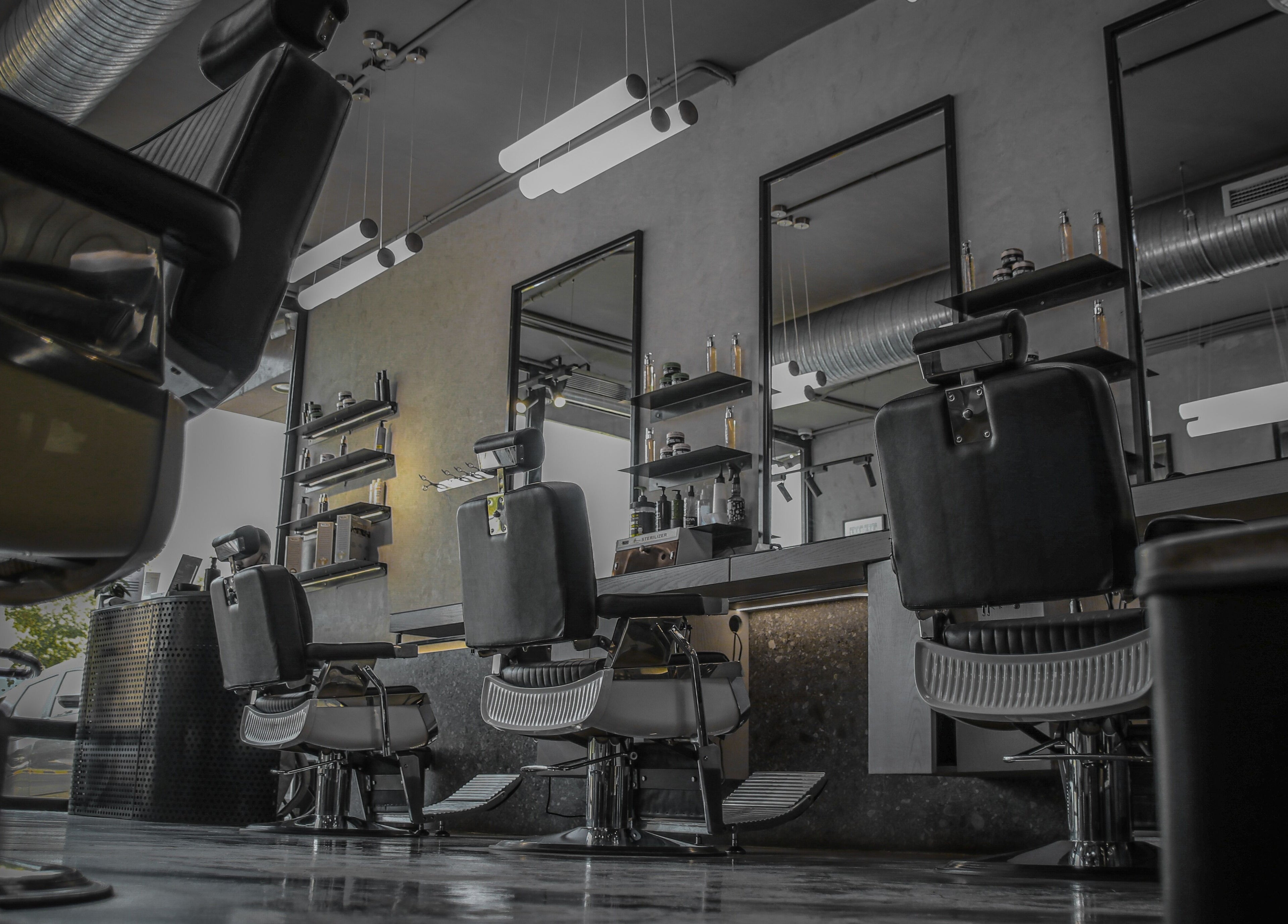 Modern interior of Double Cut Barbershop in Riyadh, Riyadh Province, SA, showcasing stylish barber chairs.