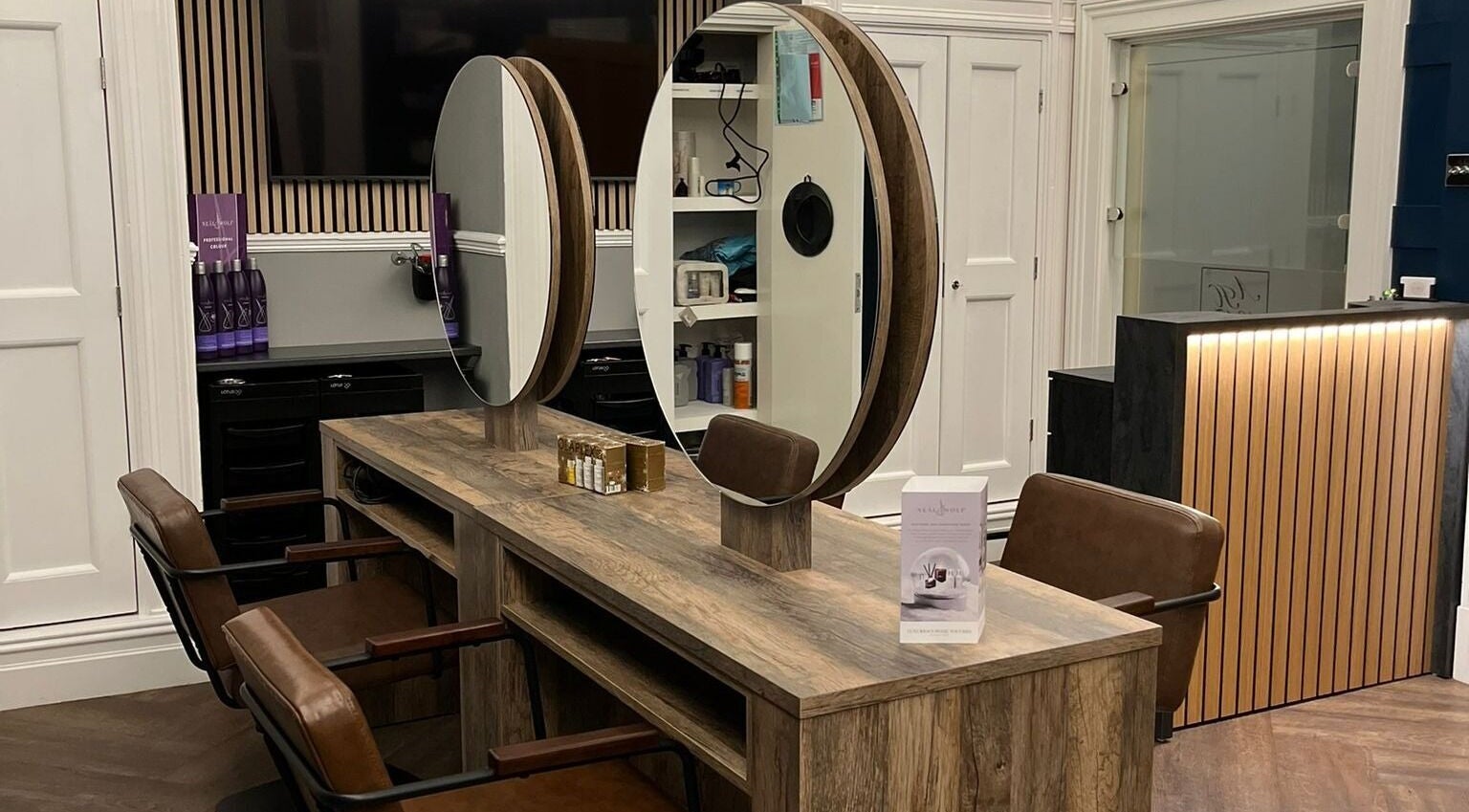 Modern styling station at Sala Hair @ Astley House, Chorley, England, GB with elegant mirrors and chairs.