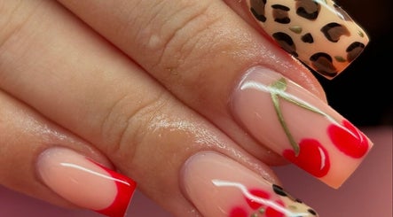 Stylish nail art at Beauty Duties, Rawreth, England, GB featuring red and leopard print designs.