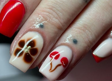 Stylish nail art with floral design at Beauty Duties, Rawreth, England, GB.