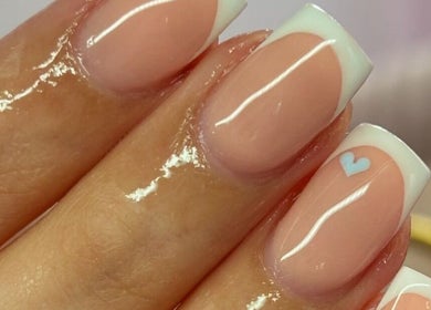 French manicure with heart design at Beauty Duties, Rawreth, England, GB. Elegant and stylish nail art.