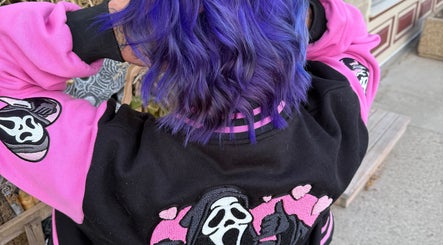 Vibrant purple hair styled at Myrna Hastings Haair, Indian Head, Saskatchewan, CA, showing unique dye work.
