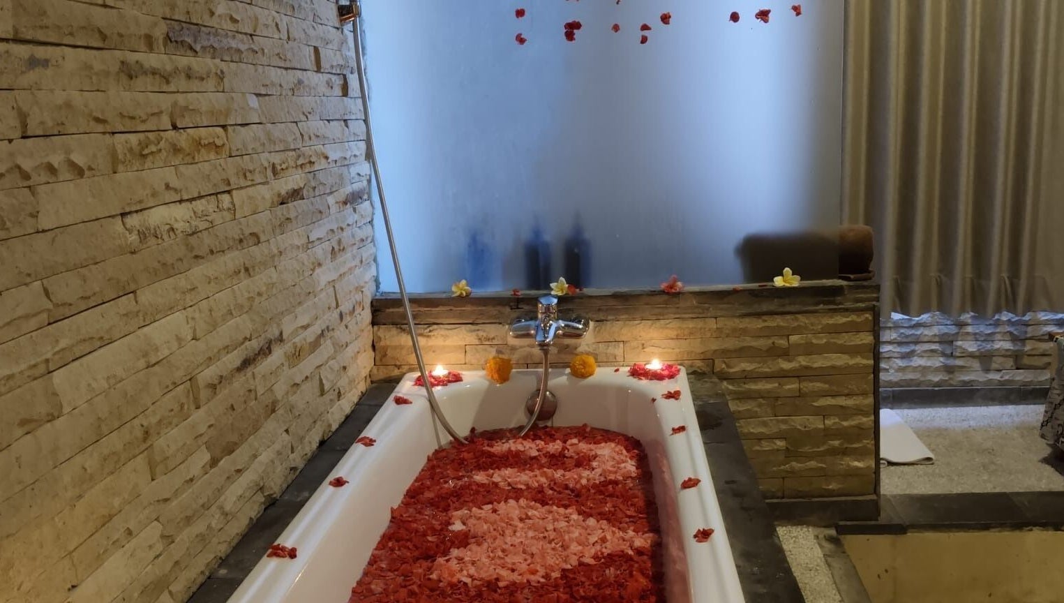 Luxurious flower-filled bathtub at Rituals Wellness Spa, Bali, Bali, ID, offering ultimate relaxation.