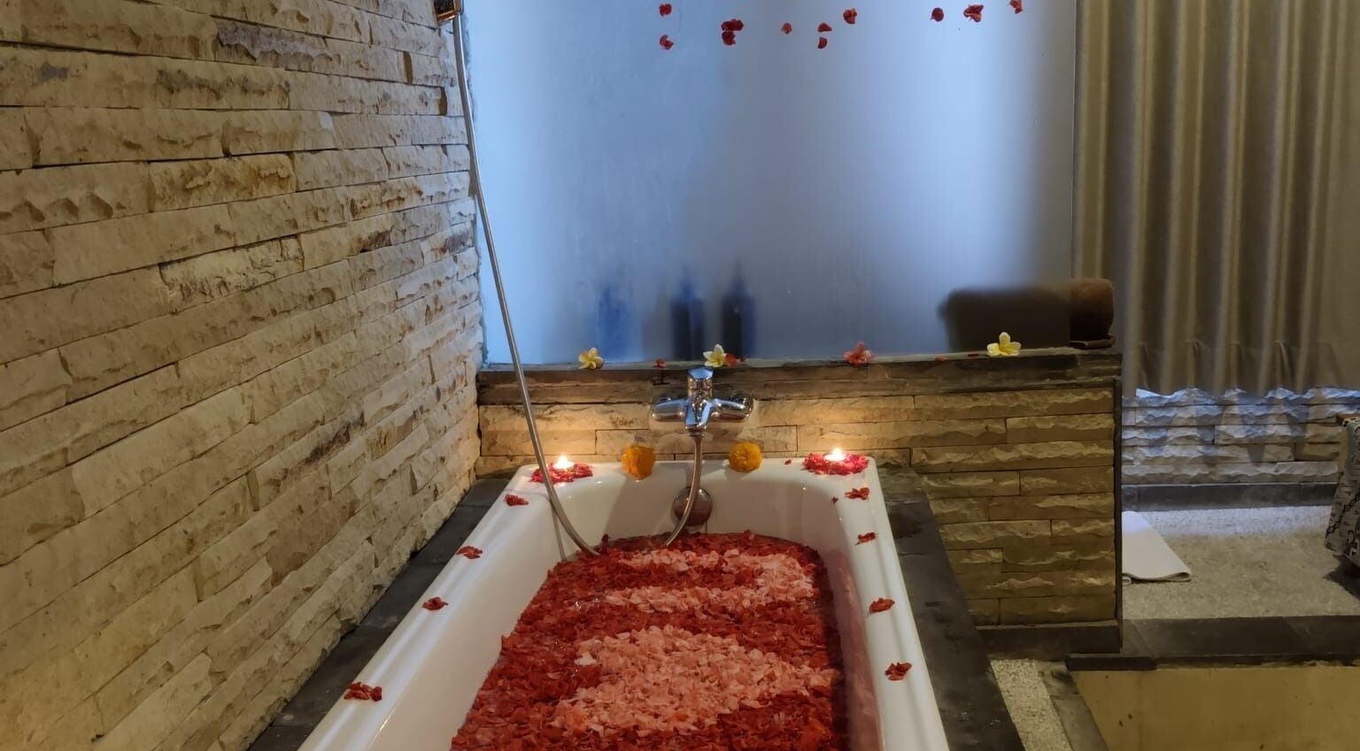 Luxurious flower-filled bathtub at Rituals Wellness Spa, Bali, Bali, ID, offering ultimate relaxation.