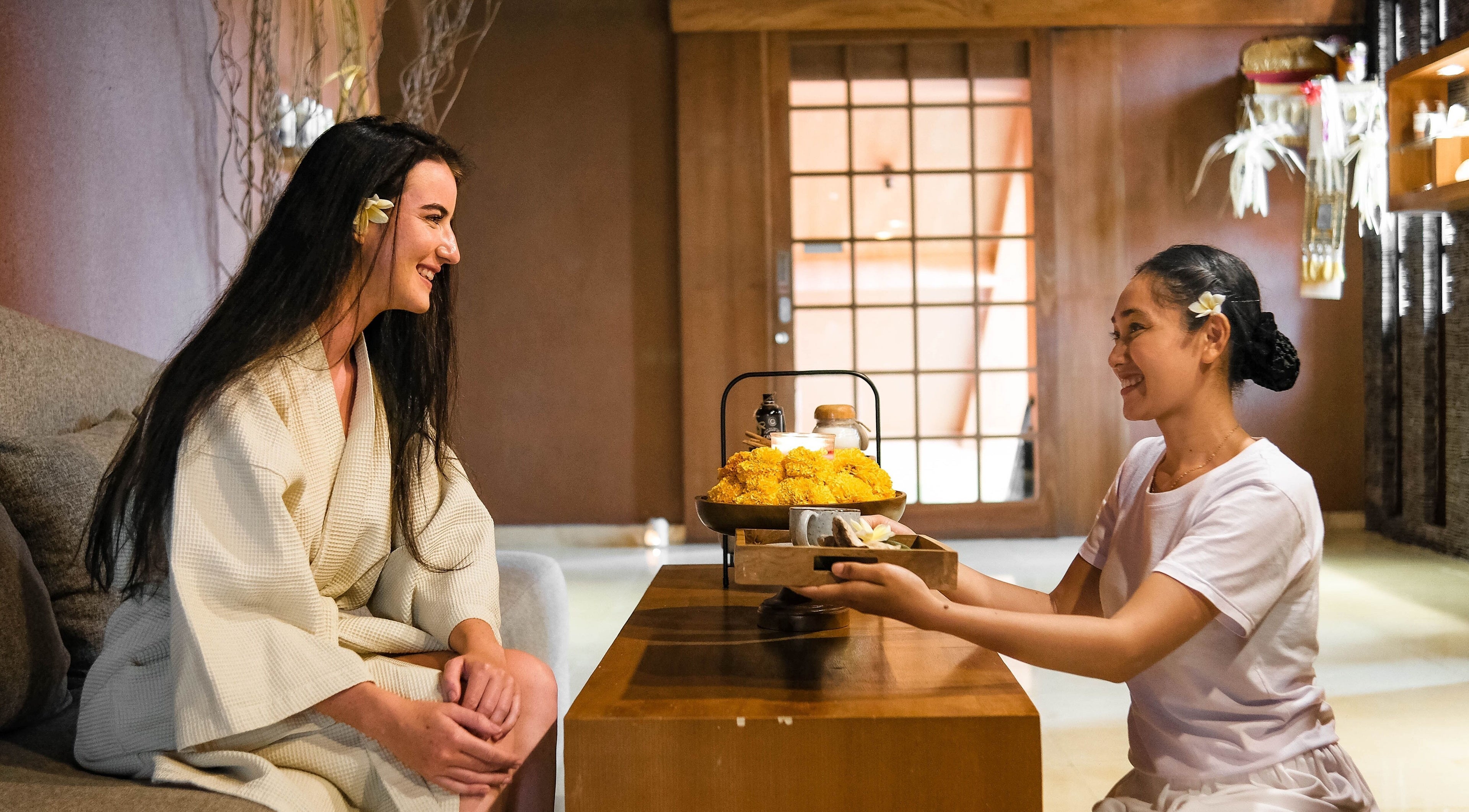 Guest receiving warm welcome at Rituals Wellness Spa, Bali, Bali, ID. Perfect ambiance for relaxation.