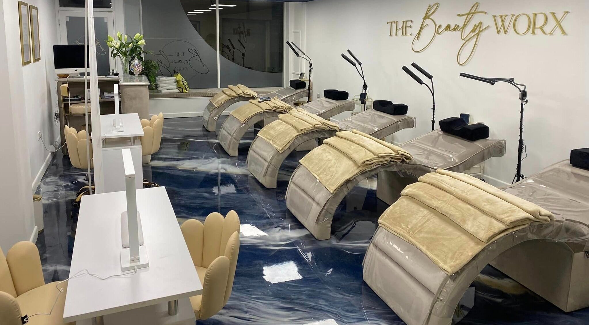 Elegant treatment room at The Beauty Worx Devon in Barnstaple, England, GB, featuring plush chairs and beds.