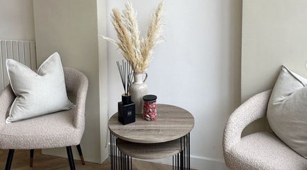 Elegant seating area at Manicured byLana, Uddingston Scotland, GB, featuring modern chairs and a stylish table.