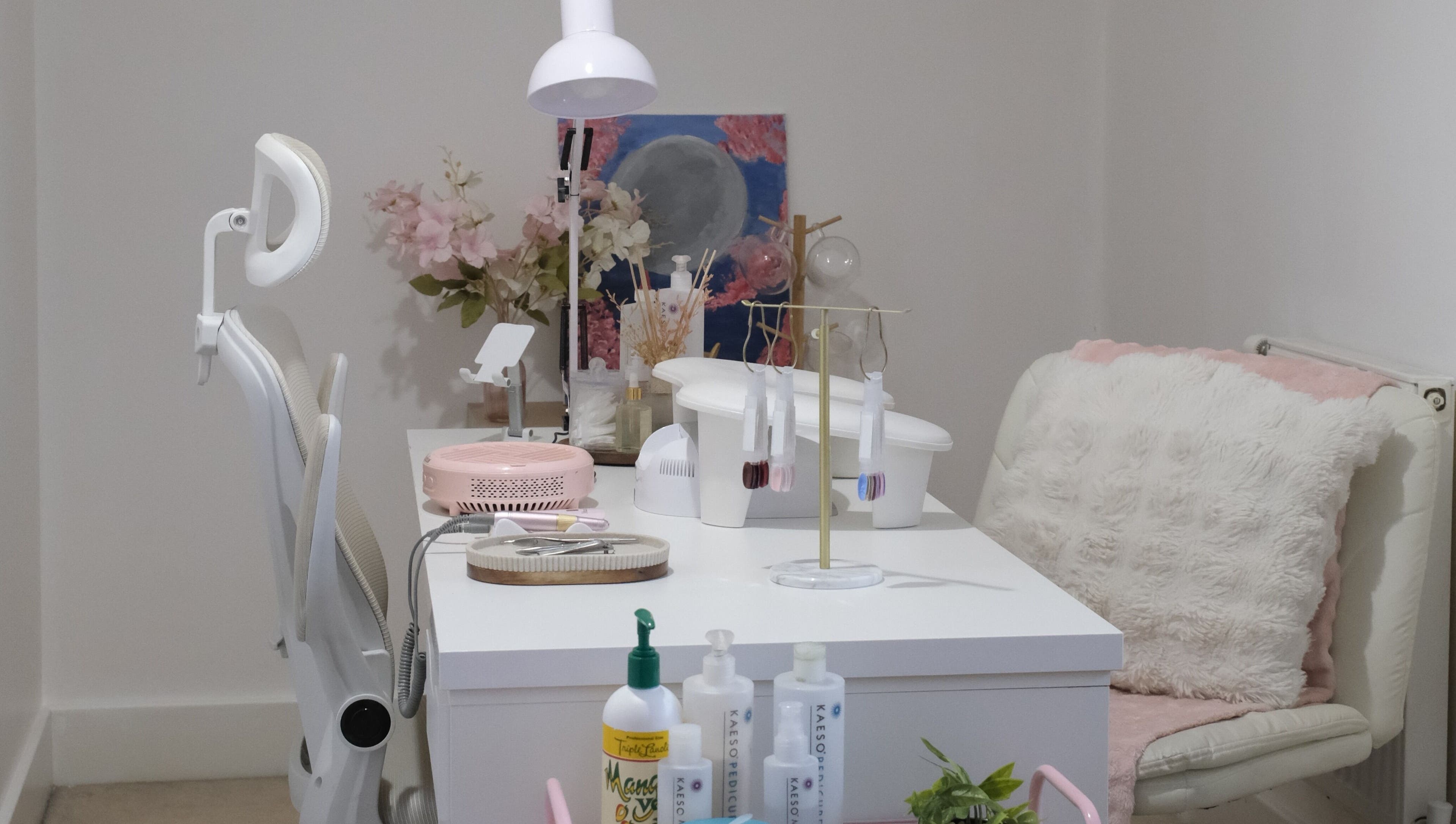 Stylish nail care station at LV Nails in Feltham, England, GB with modern decor and plush seating.