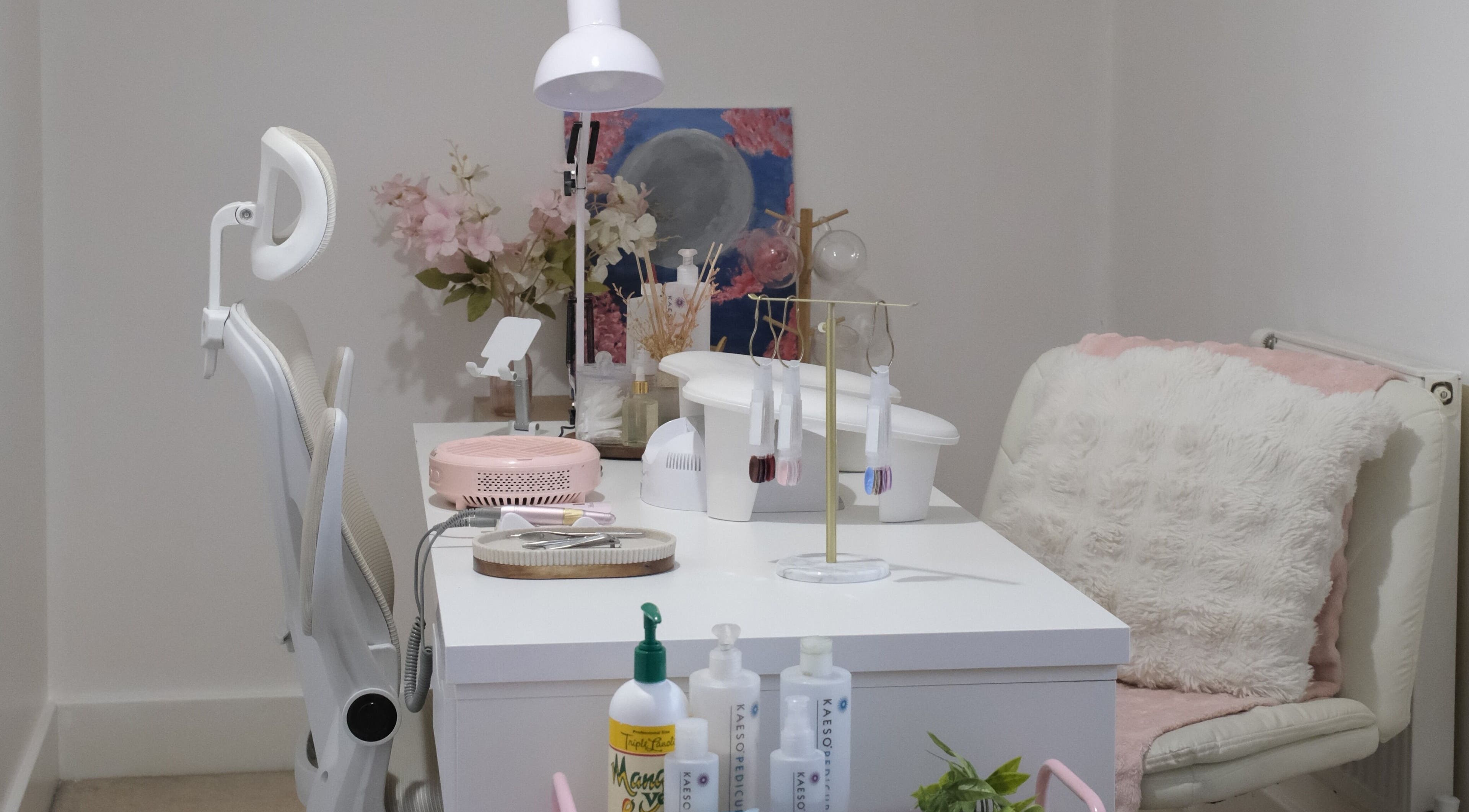 Stylish nail care station at LV Nails in Feltham, England, GB with modern decor and plush seating.