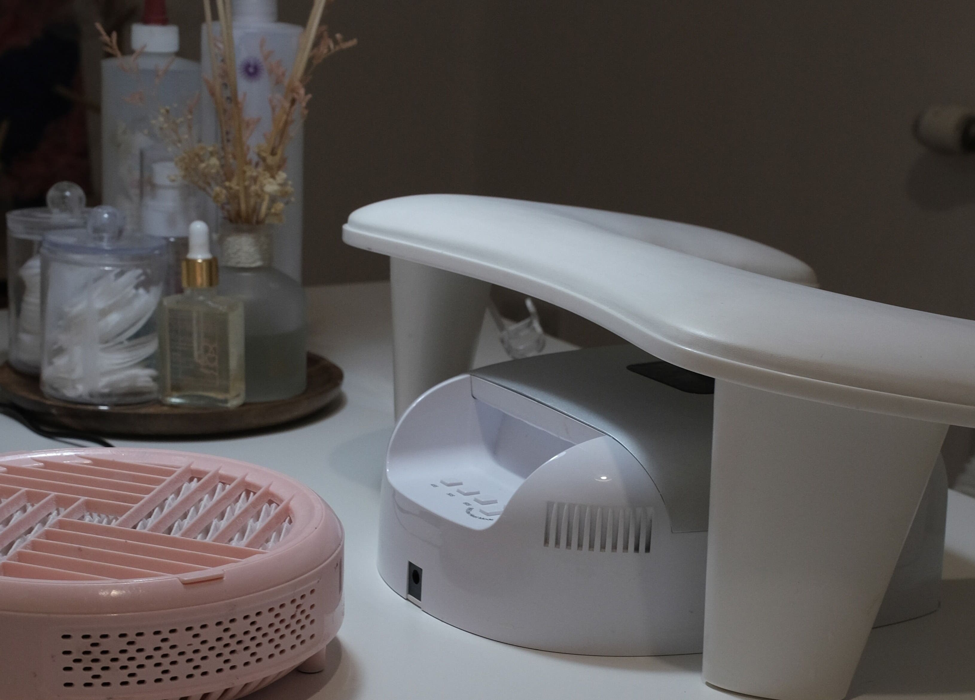 Nail care setup at LV Nails, Feltham, England. Features a pink dryer and white armrest.