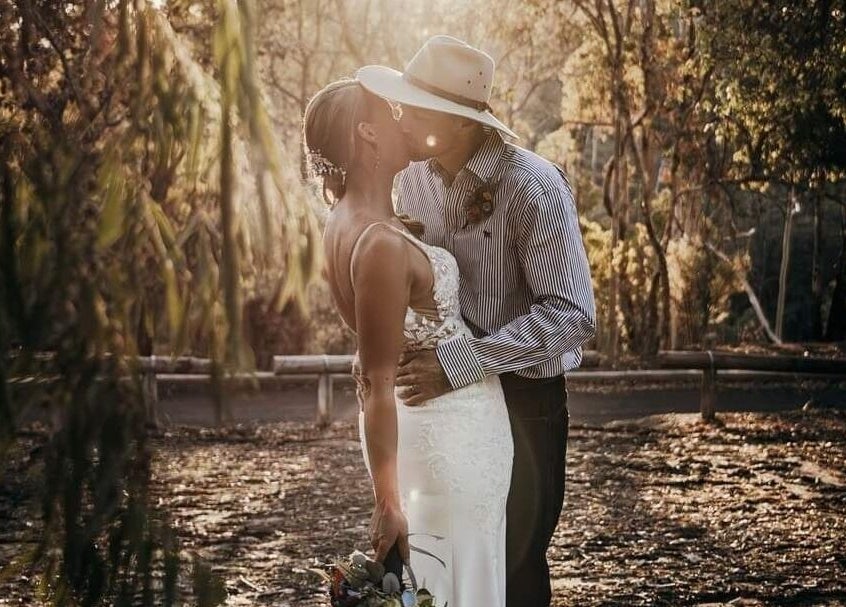 Couple embracing in a serene forest at Glow Tribe Spray Tanning, Glen Forrest, Western Australia, AU.