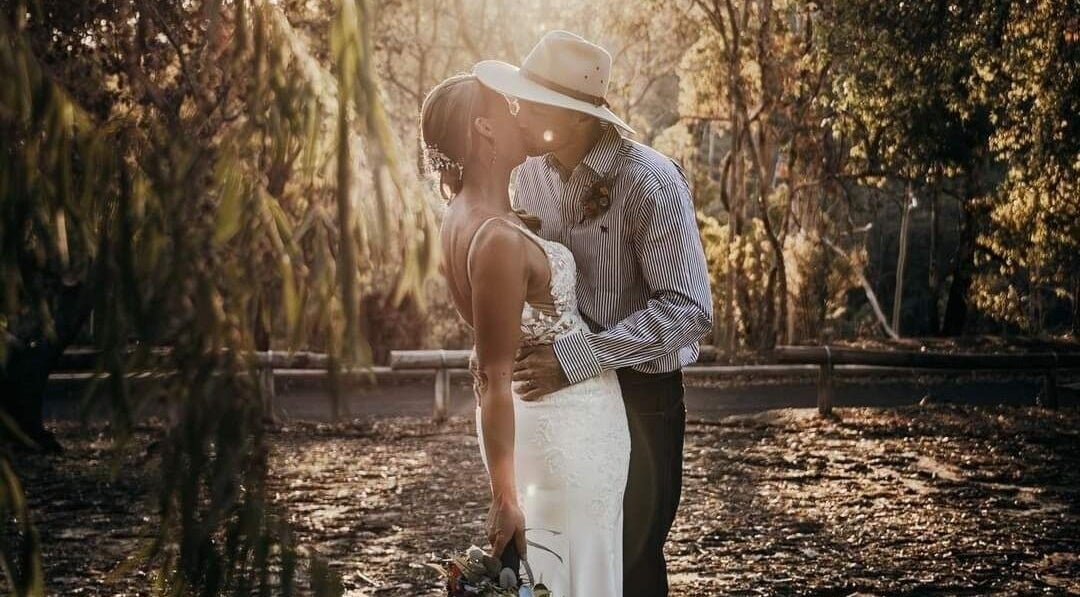 Couple embracing in a serene forest at Glow Tribe Spray Tanning, Glen Forrest, Western Australia, AU.