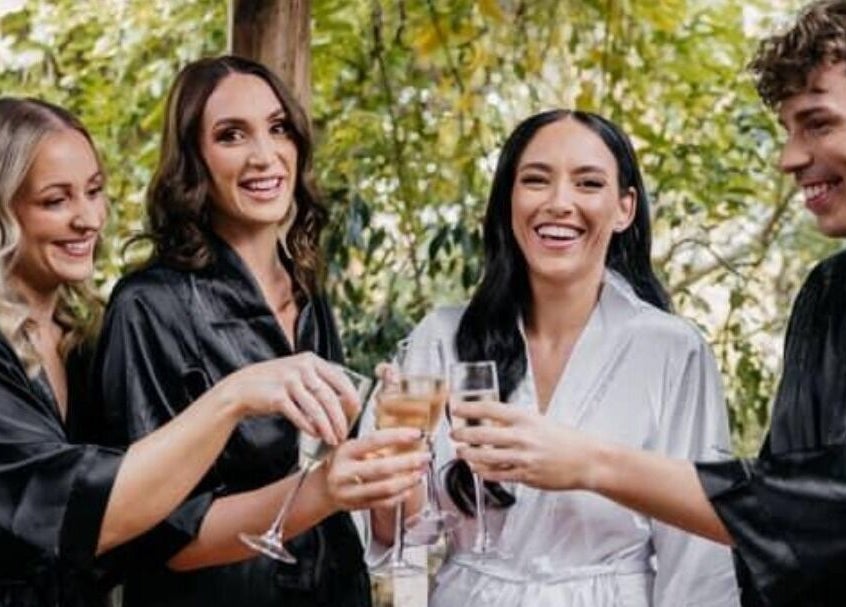 Friends toast at Glow Tribe Spray Tanning, Glen Forrest, Western Australia, AU, enjoying a relaxed ambiance.