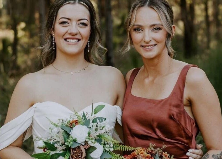 Two smiling women in formal attire at Glow Tribe Spray Tanning, Glen Forrest, Western Australia, AU.