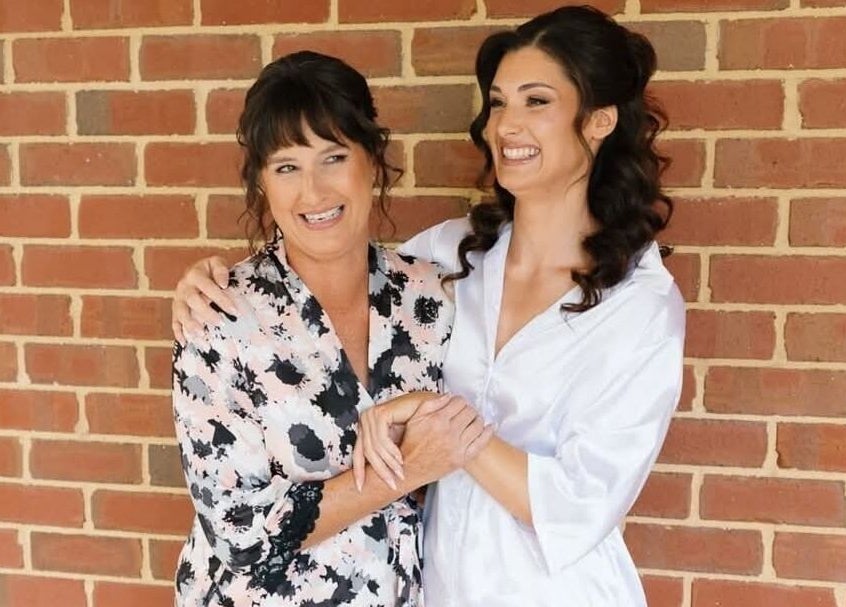 Two happy women hugging at Glow Tribe Spray Tanning, Glen Forrest, Western Australia, AU.