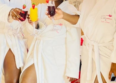 Guests in robes toast with drinks at Bohl Squared Beauty Spa, Springs, Gauteng, ZA.