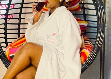 Guest enjoying a drink in a cozy robe at Bohl Squared Beauty Spa, Springs, Gauteng, ZA.