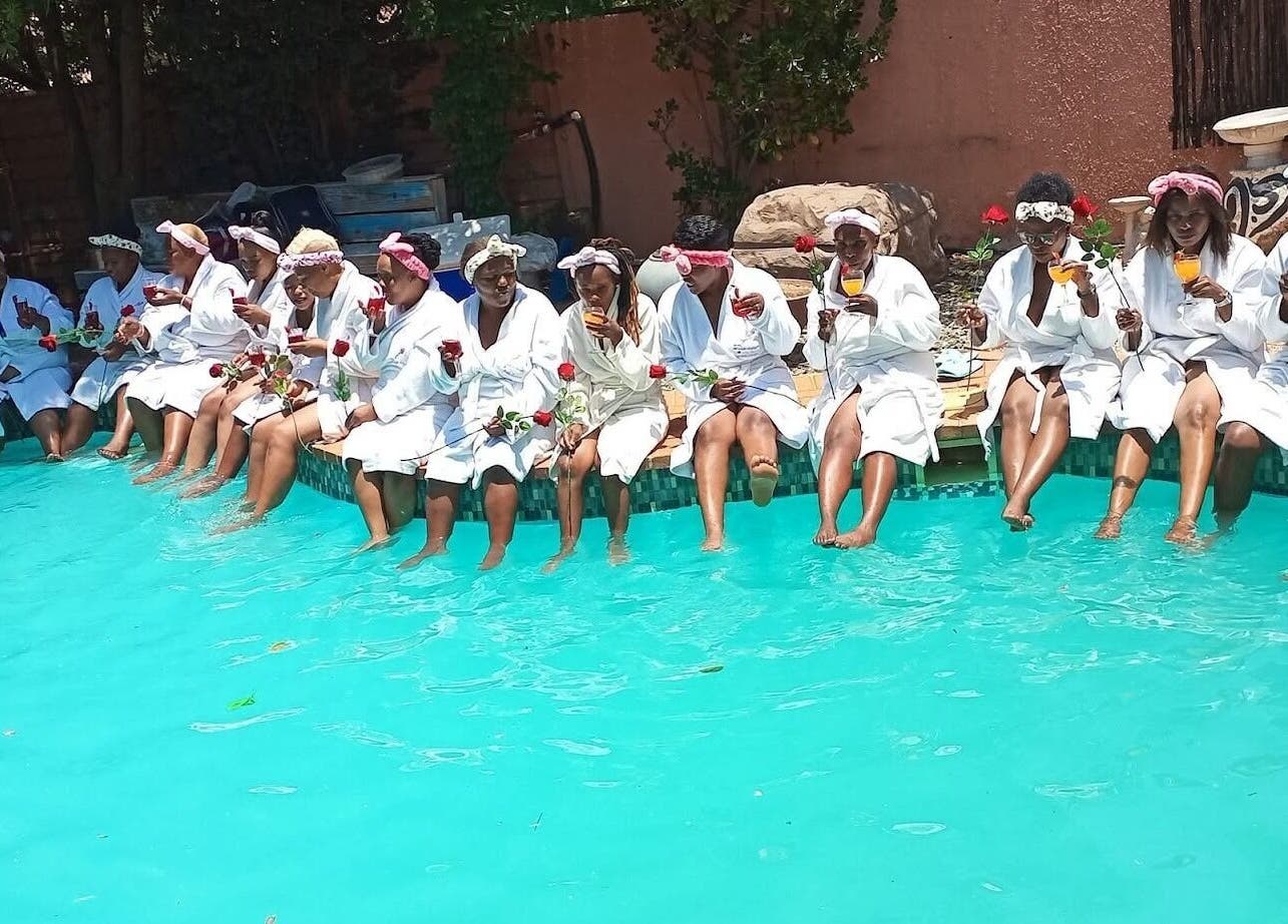 Group of women in robes enjoying by the pool at Bohl Squared Beauty Spa, Springs, Gauteng, ZA.