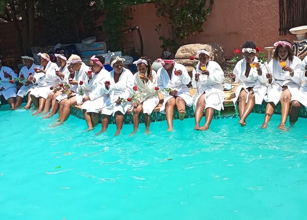 Group of women in robes enjoying by the pool at Bohl Squared Beauty Spa, Springs, Gauteng, ZA.