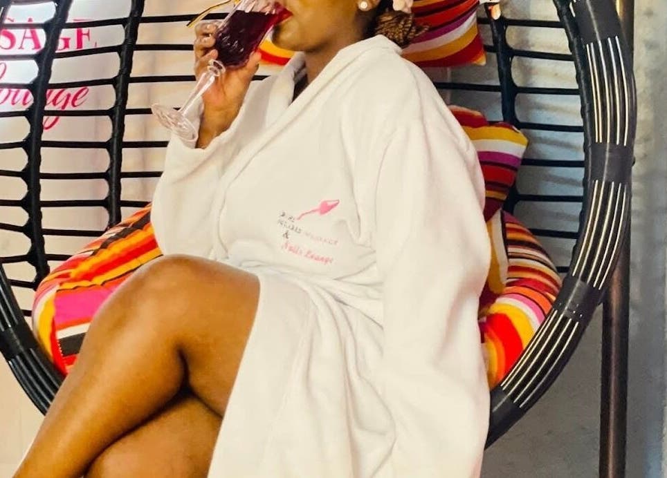 Guest enjoying a beverage at Bohl Squared Beauty Spa, Springs, Gauteng, ZA in a cozy spa chair.