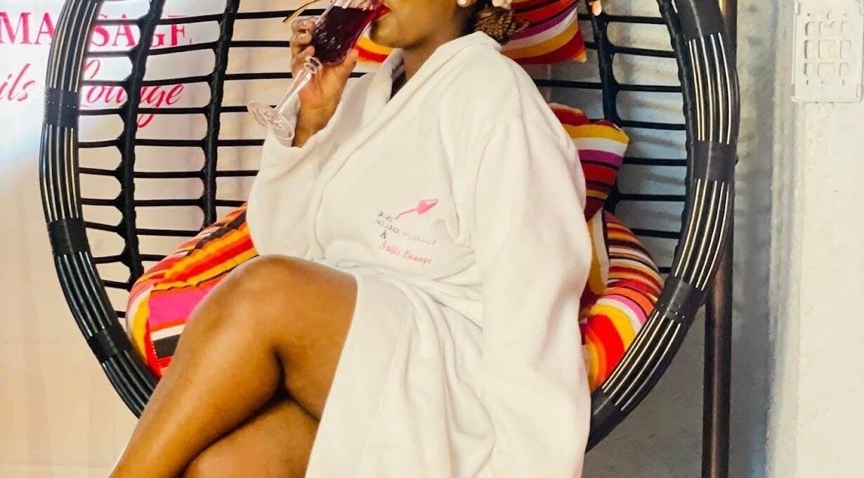 Guest enjoying a beverage at Bohl Squared Beauty Spa, Springs, Gauteng, ZA in a cozy spa chair.