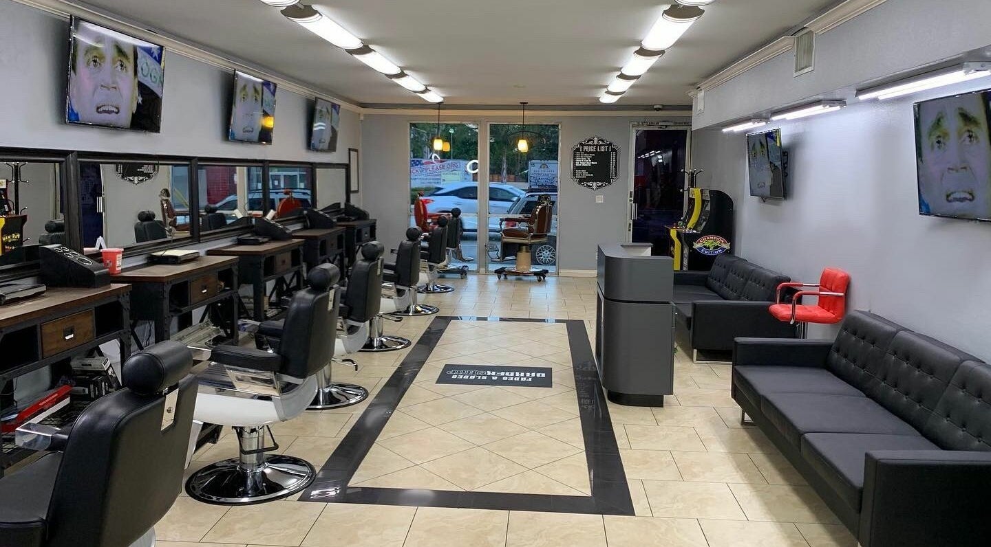 Modern interior of Fades & Blades Valley Glen, Los Angeles, California, US with stylish barber chairs and decor.