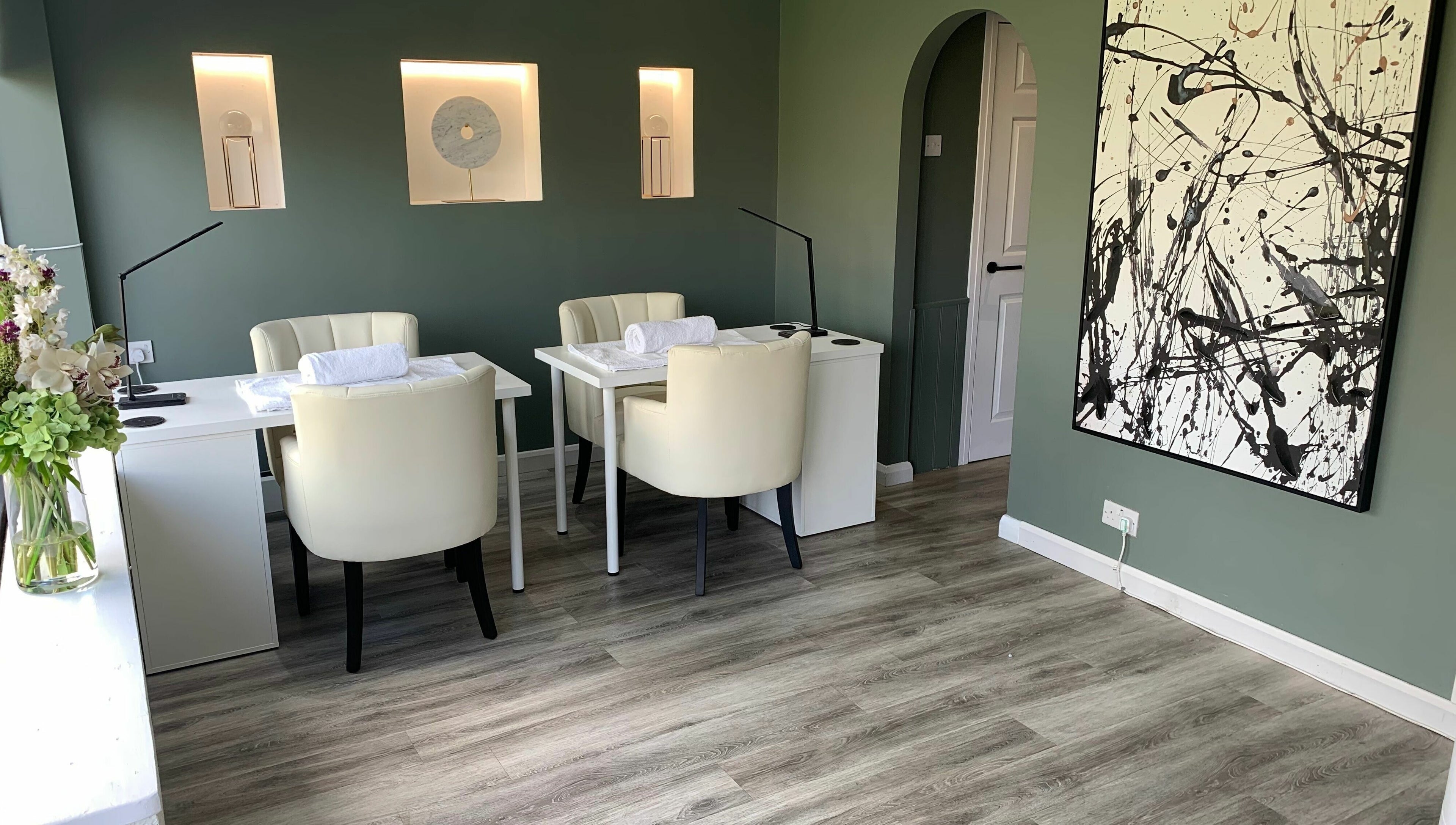Elegant beauty room at Harmony in Brentwood, England, GB with modern decor and calming green walls.