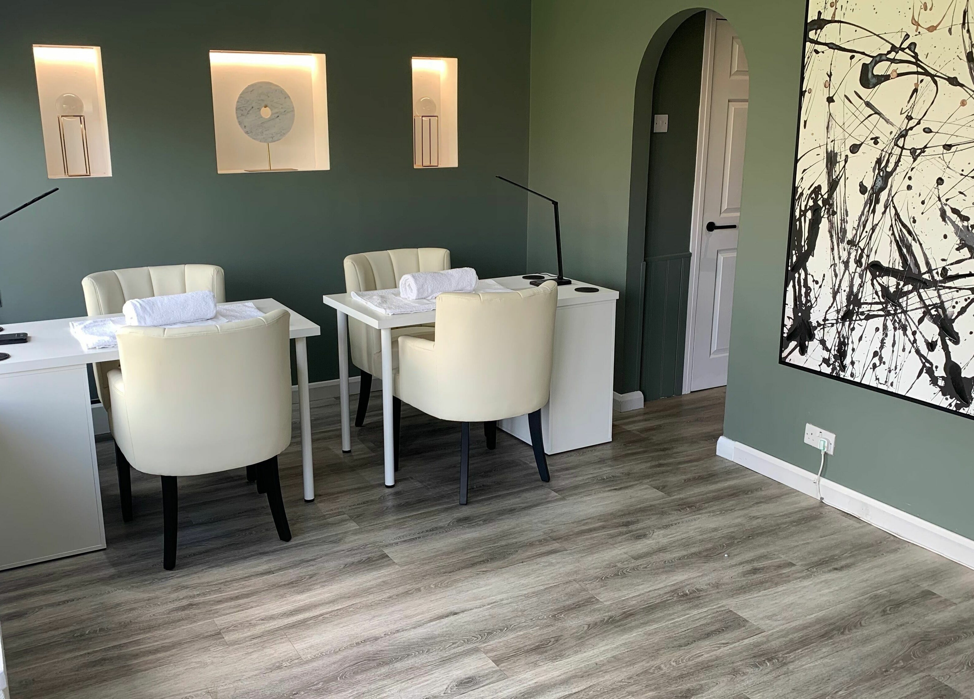 Elegant beauty room at Harmony in Brentwood, England, GB with modern decor and calming green walls.