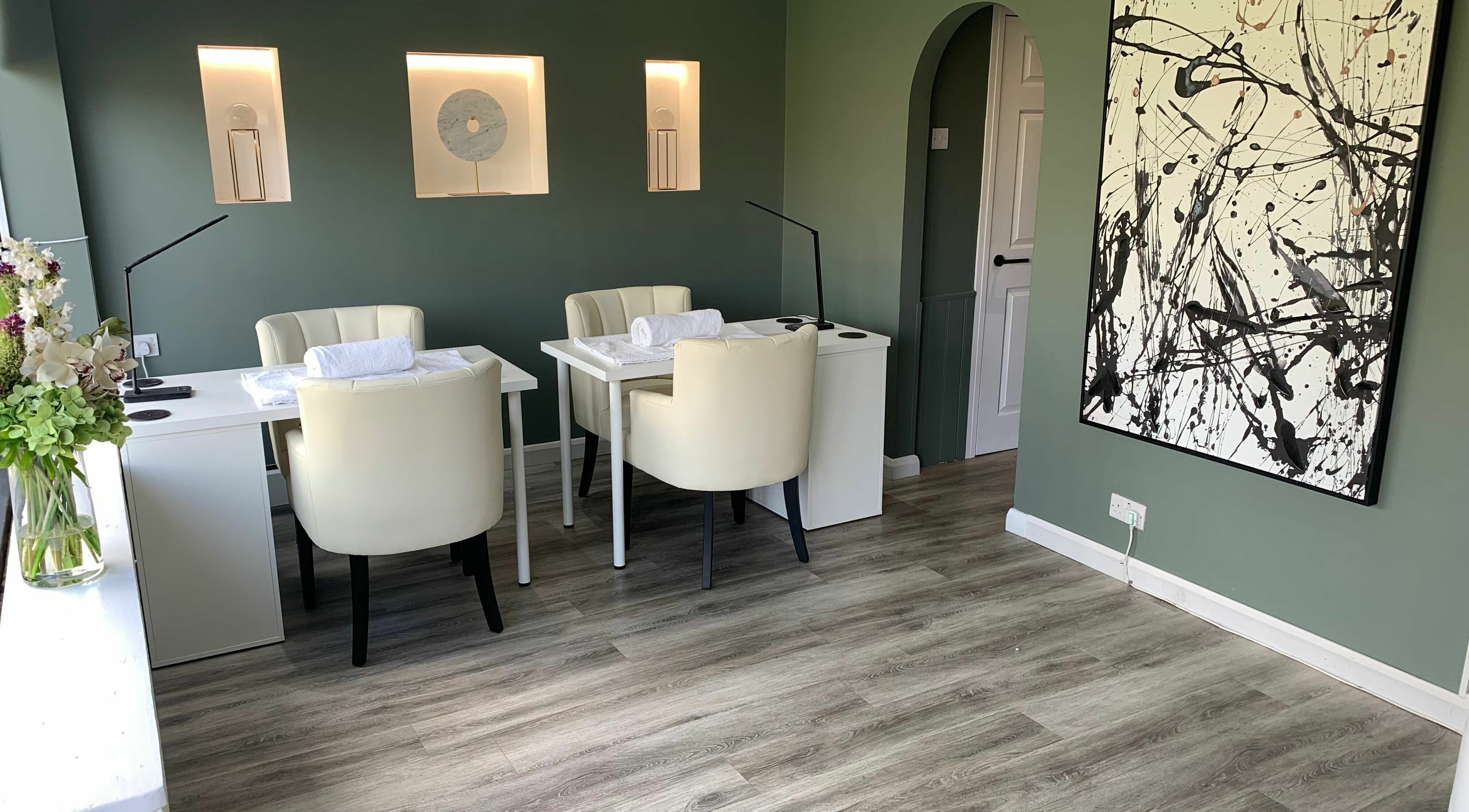 Elegant beauty room at Harmony in Brentwood, England, GB with modern decor and calming green walls.