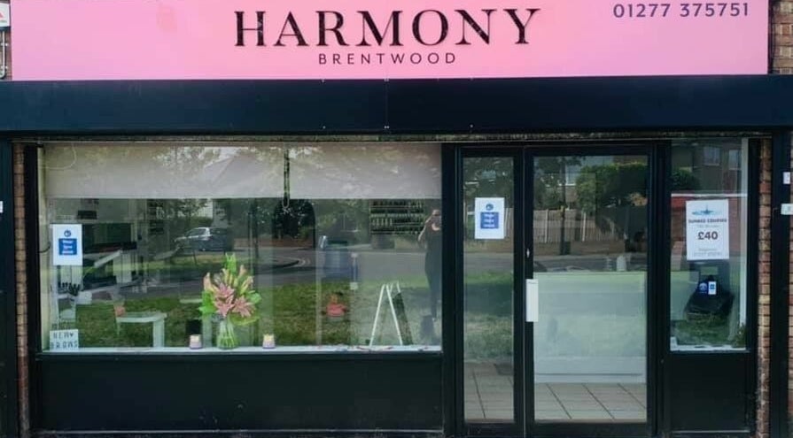 Front view of Harmony salon in Brentwood, England, GB, showcasing elegant storefront design.