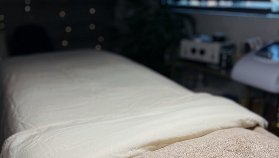 Cozy massage table at Mnmlsm Beauty in Toronto, Ontario, CA, featuring soft ambient lighting.