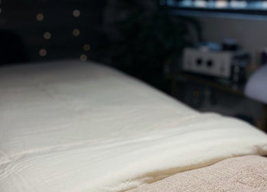 Cozy massage table at Mnmlsm Beauty in Toronto, Ontario, CA, featuring soft ambient lighting.