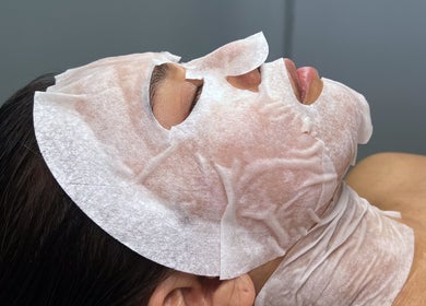 Relaxing face mask treatment at Mnmlsm Beauty in Toronto, Ontario, CA, showcasing ultimate skincare experience.