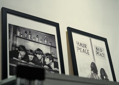 Decorative framed art at FOXHOUND Barbershop, Macao, MO adds a vintage touch to the ambiance.