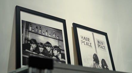 Decorative framed art at FOXHOUND Barbershop, Macao, MO adds a vintage touch to the ambiance.